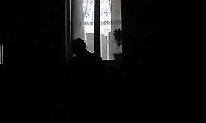 Peeping through windows. Voyeur. In evening, on street random passerby guy looking into bedroom window and filming on camera smartphone as sexy blonde MILF undresses, goes to bed, masturbates pussy, gets strong wet orgasm. Outdoors Outside