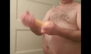 Nude Martin Lavallée lubricates, kisses and engulfs his big 8 inch dildo